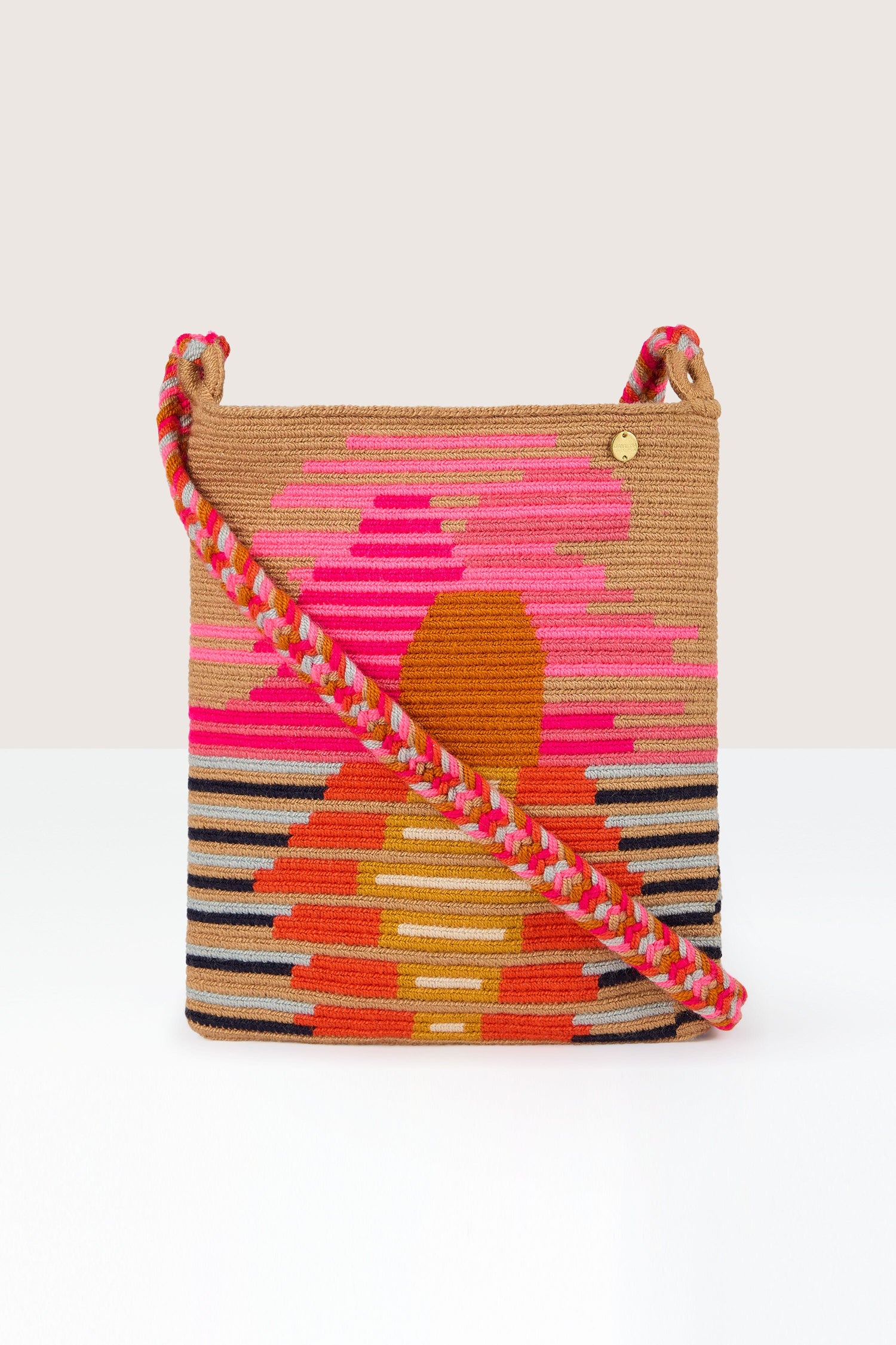 Handcrafted Rectangular Crossbody Bag with geometric pattern in pink, orange, and brown hues, handcrafted by skilled artisans and featuring a braided shoulder strap.