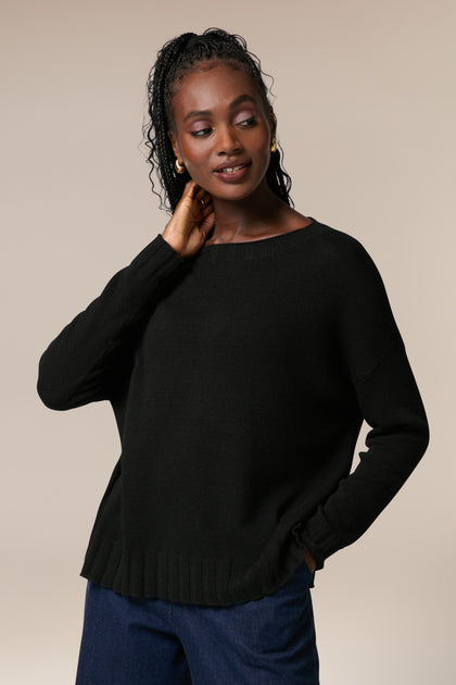 A model wearing a black Cashmere Merino Crop Jumper sweater.