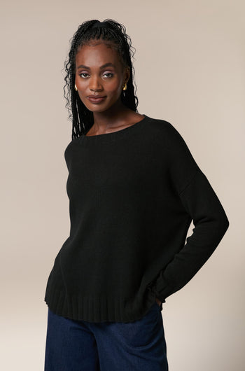 A woman wearing a Cashmere Merino Crop Jumper and jeans.