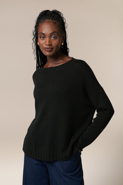 A woman wearing a Cashmere Merino Crop Jumper and jeans.