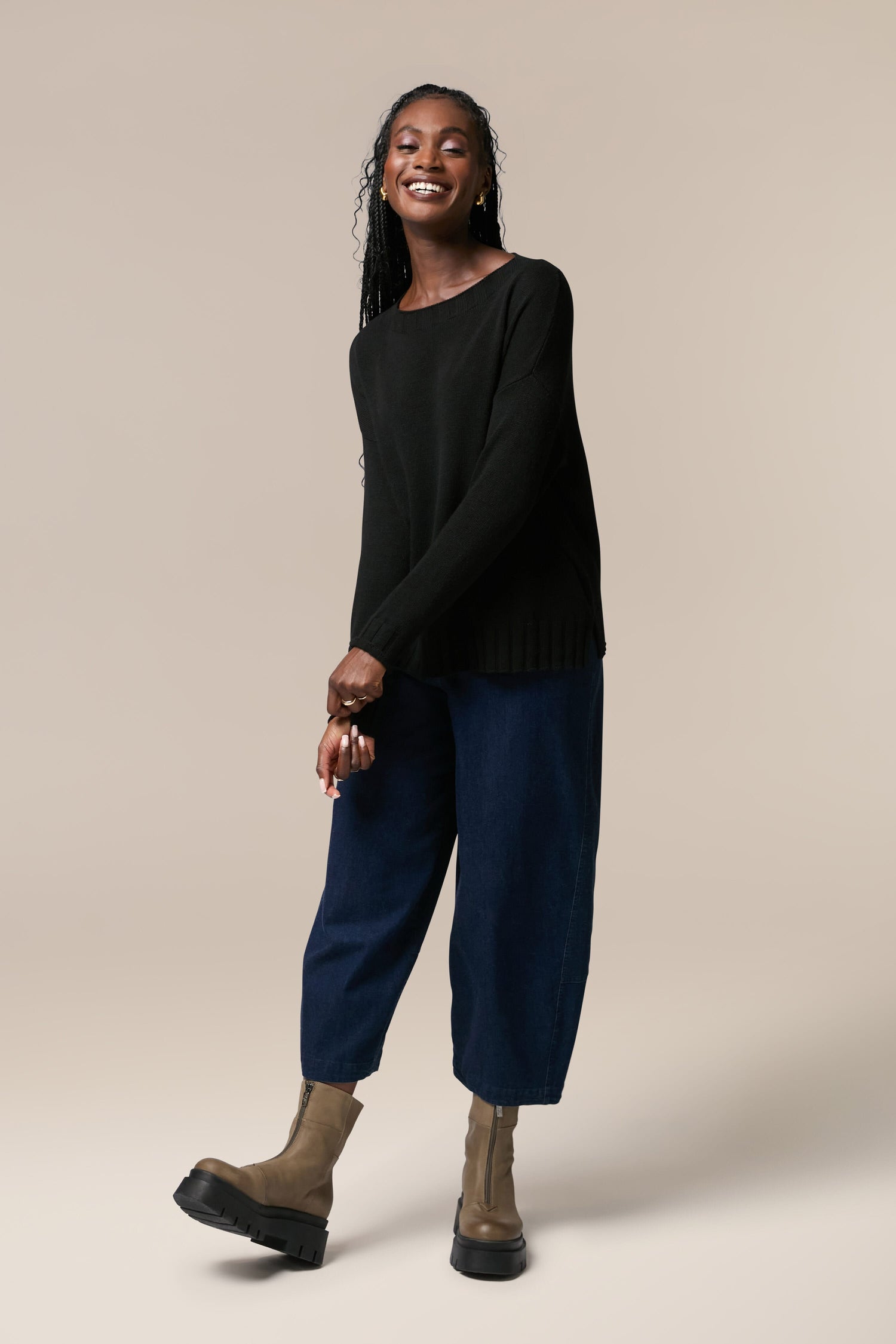 A woman wearing a Cashmere Merino Crop Jumper crafted from luxurious cashmere.