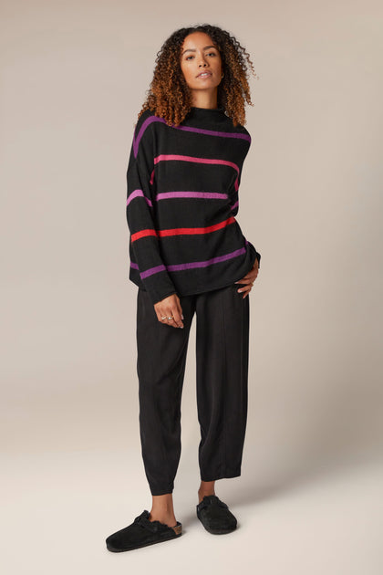A woman wearing a Mohair Blend Stripe Sweater and pants.