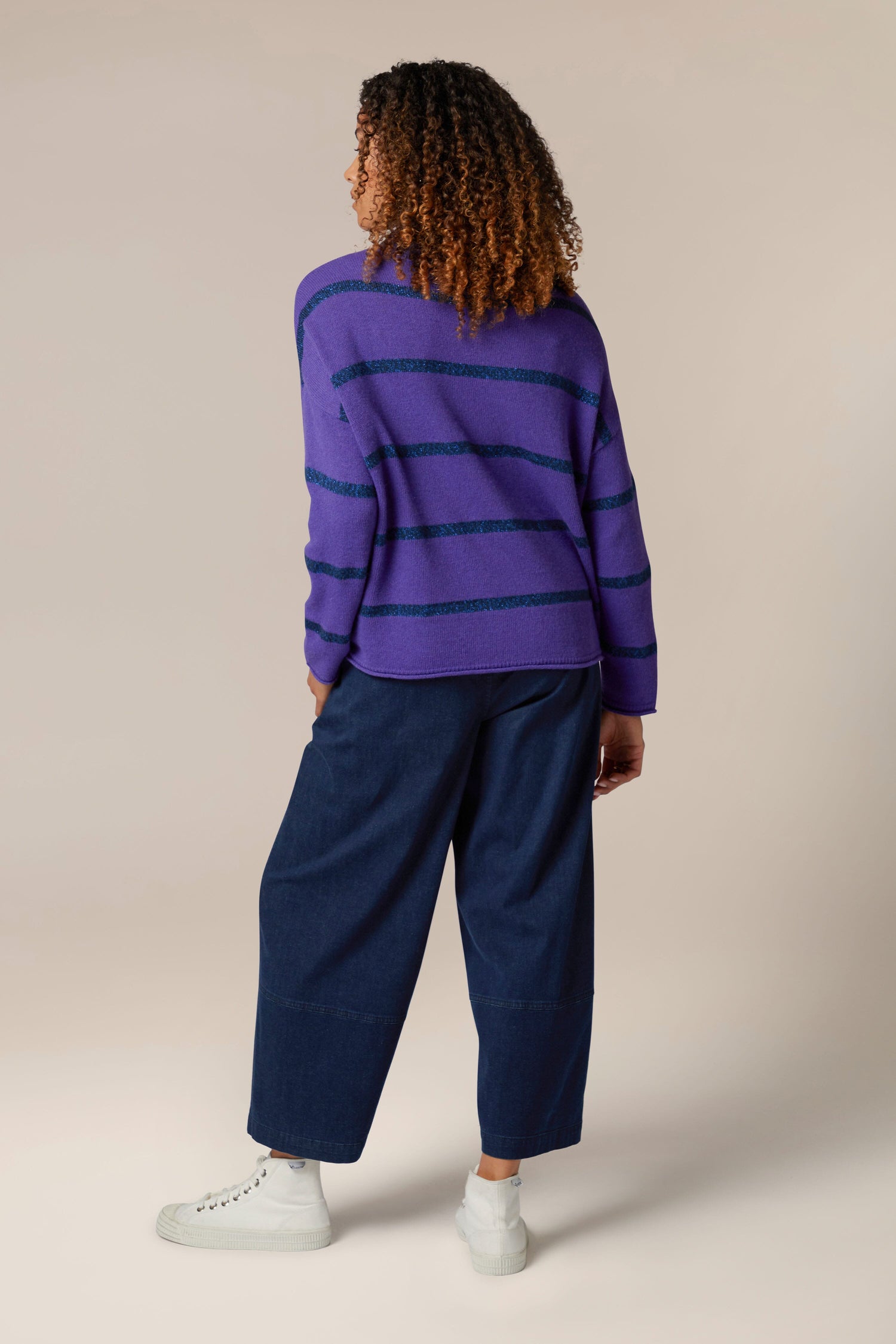 A woman in a Plaited Stripe Sweater.