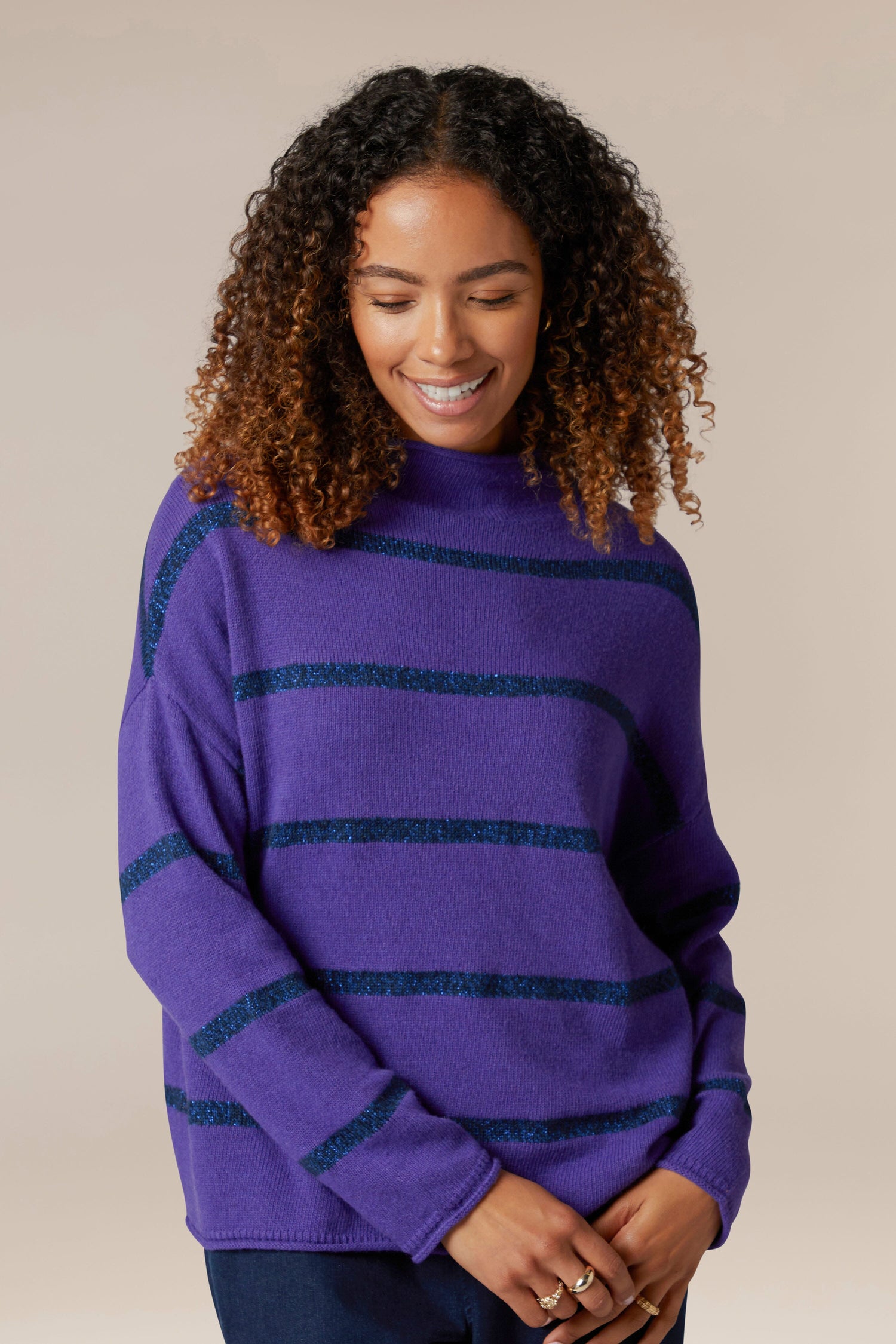 A woman wearing a Plaited Stripe Sweater.