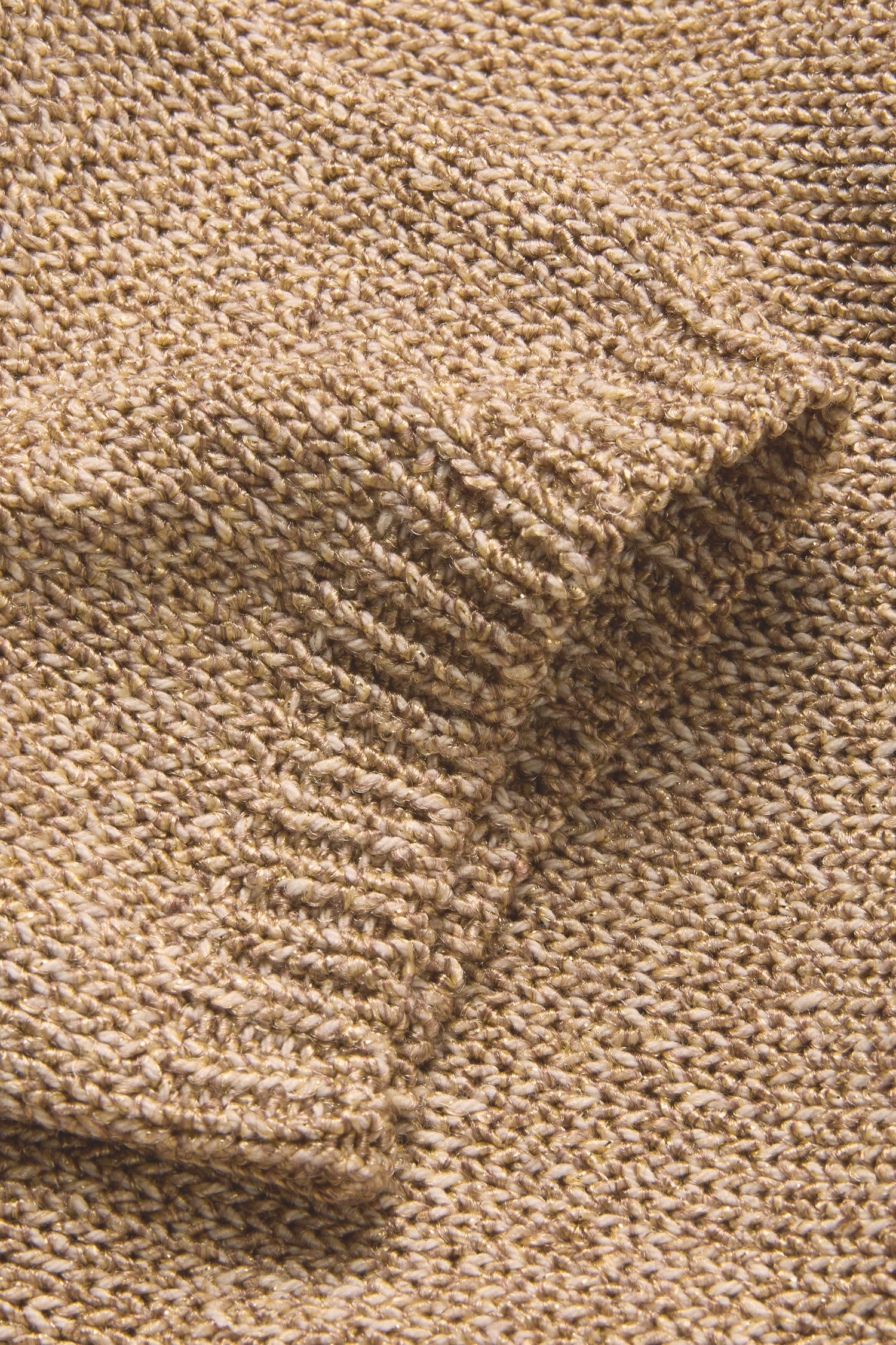 Close-up of Champagne Boxy Sparkle Knit Jumper in tan, highlighting a folded edge and its detailed woven texture.