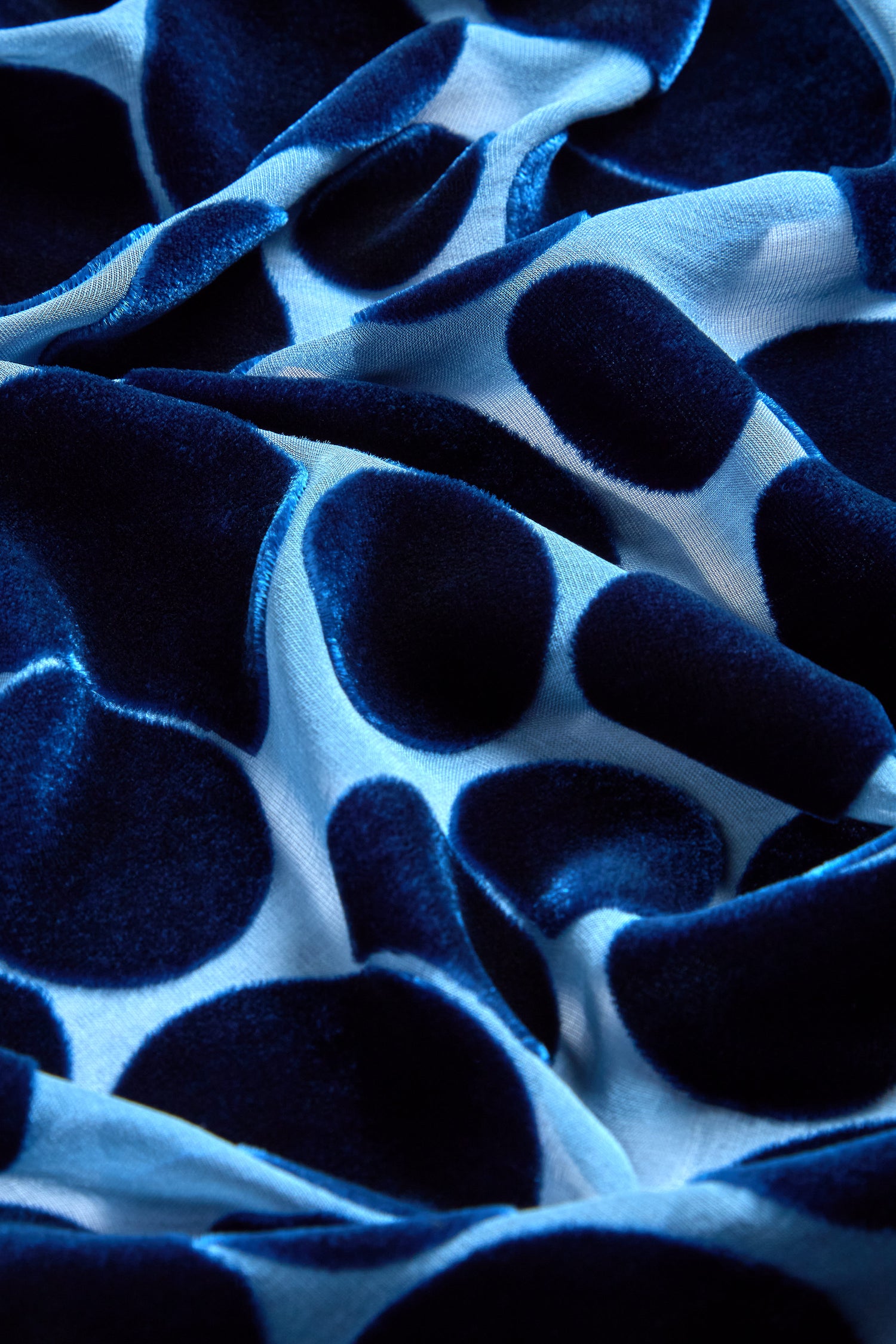 Close-up of the Spot Devore Top showcasing blue velvet devore fabric with large, dark blue polka dots.