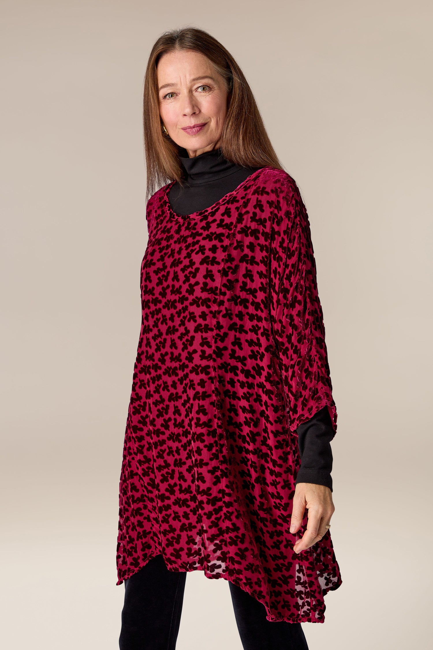 A woman wearing a Grizas Devore Tunic in a red and black leopard print pattern.