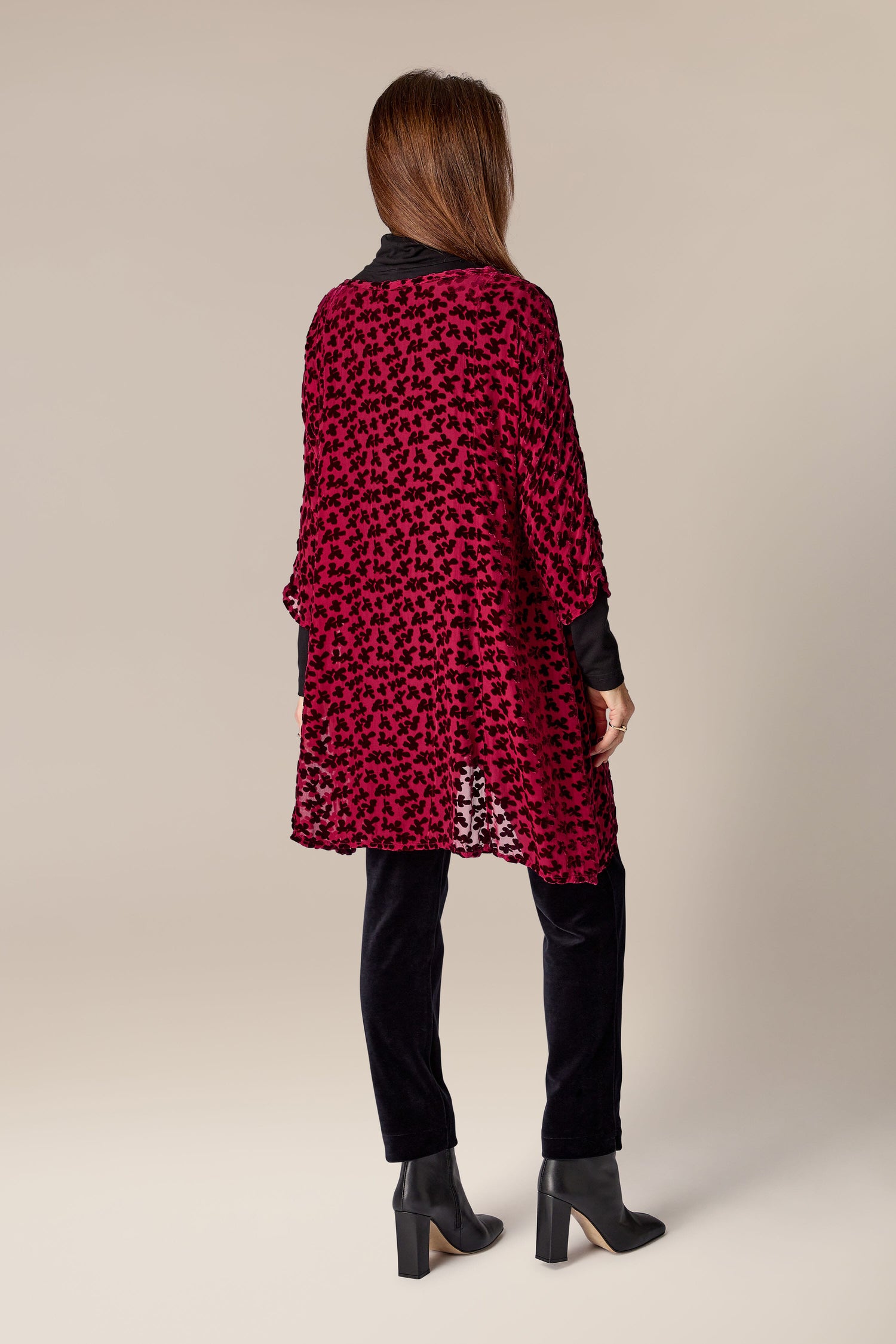 The back view of a woman wearing a burned-out velvet leopard print Devore Tunic from Grizas.