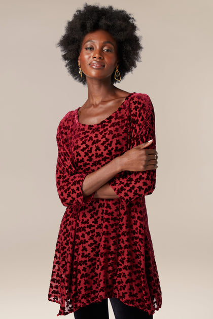 A black woman wearing a [Devore Tunic] and leggings.
