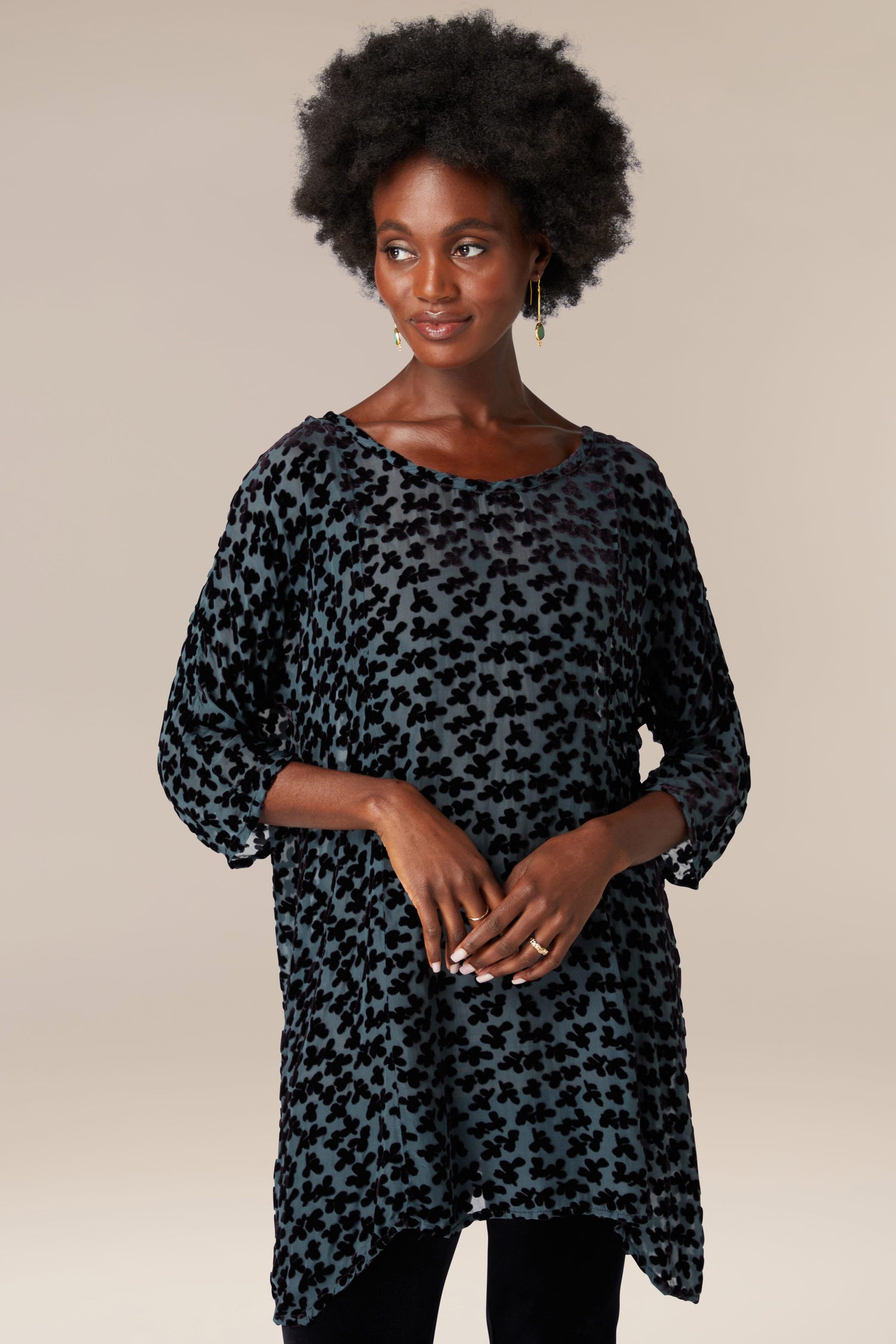A woman donning a Devore Tunic.