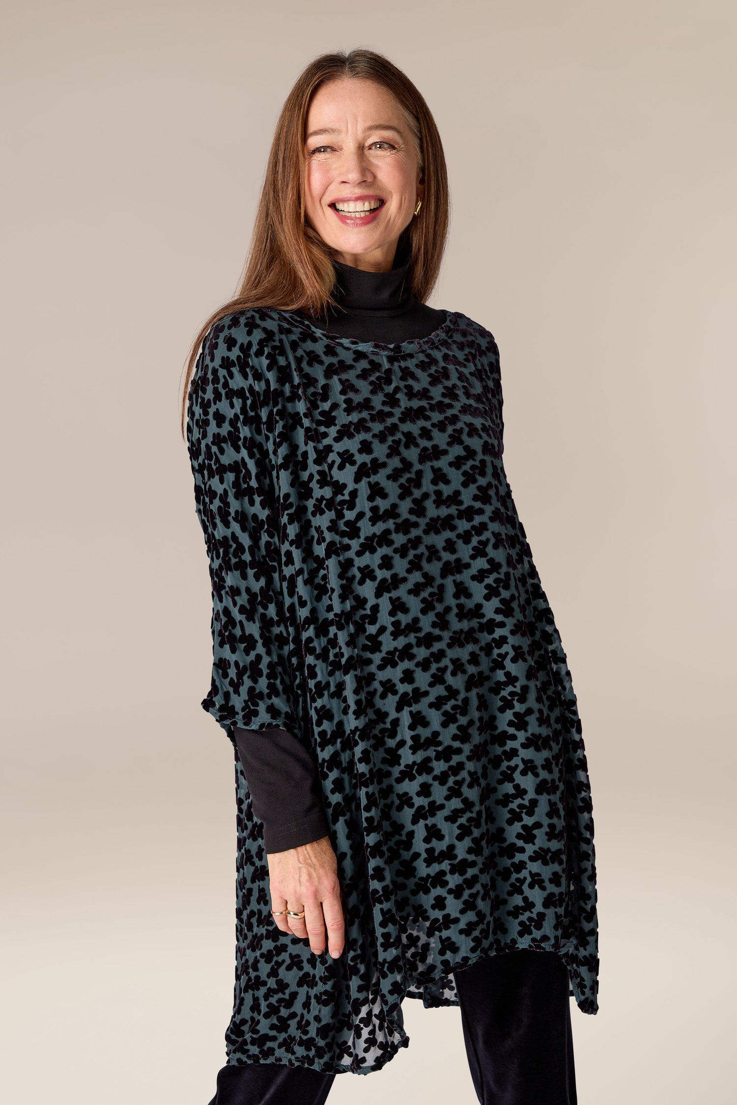 A woman wearing a "Devore Tunic" with a leopard print.