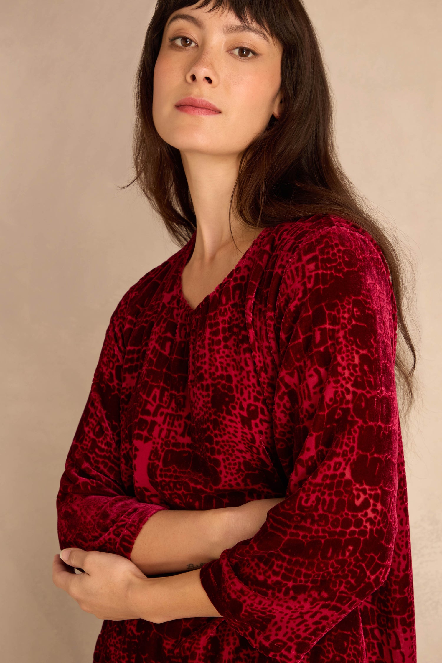Woman with long dark hair wears the Ruby Leopard Devore Layered Top against a neutral background, looking calmly at the camera.