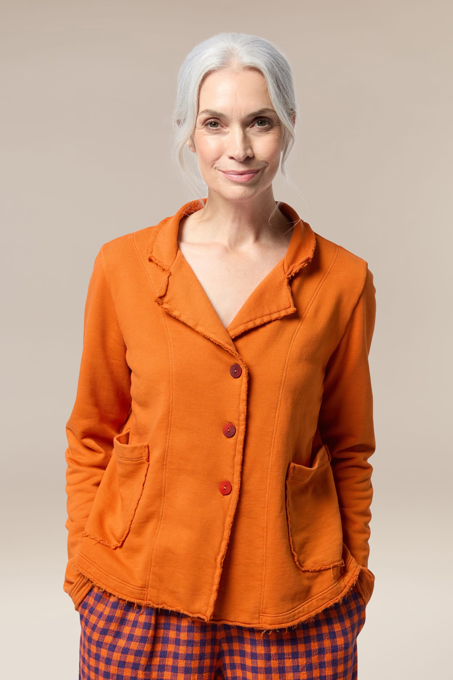 A woman wearing a cotton collar jacket and plaid pants.