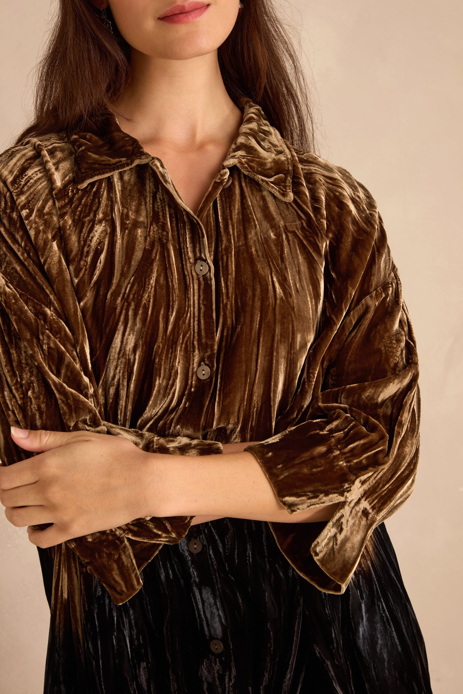 Woman wearing an Olive Silk Velvet Ombre Shirt with long sleeves, standing against a neutral background, arms folded.