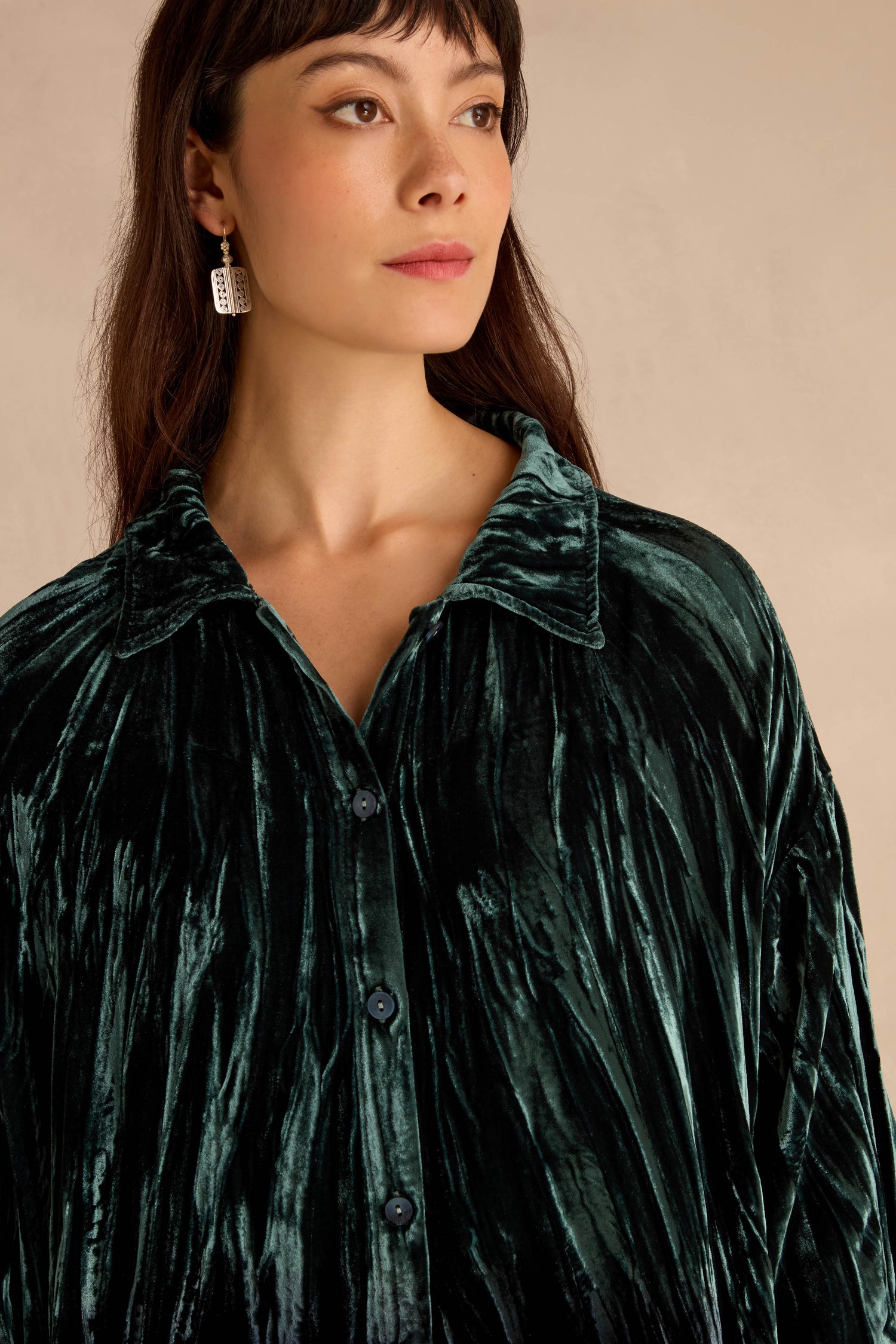 Woman wearing a Turquoise Silk Velvet Ombre Shirt with a collar, looking to the side against a neutral background.