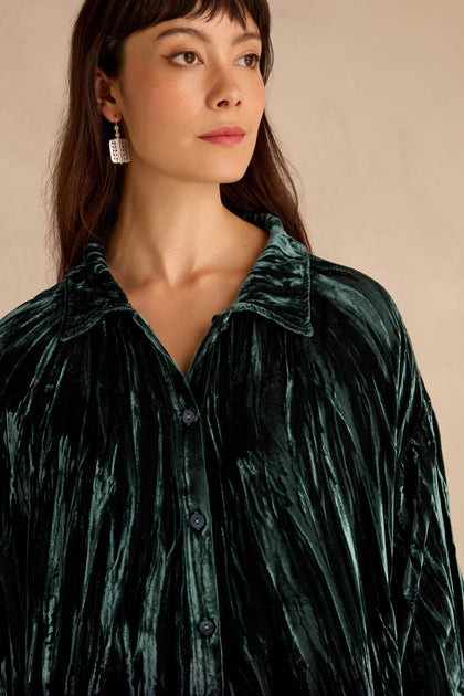 Woman wearing a Turquoise Silk Velvet Ombre Shirt with a collar, looking to the side against a neutral background.