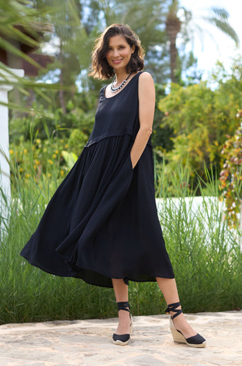 A woman wearing a Morrocain Sleeveless Dress and sandals.