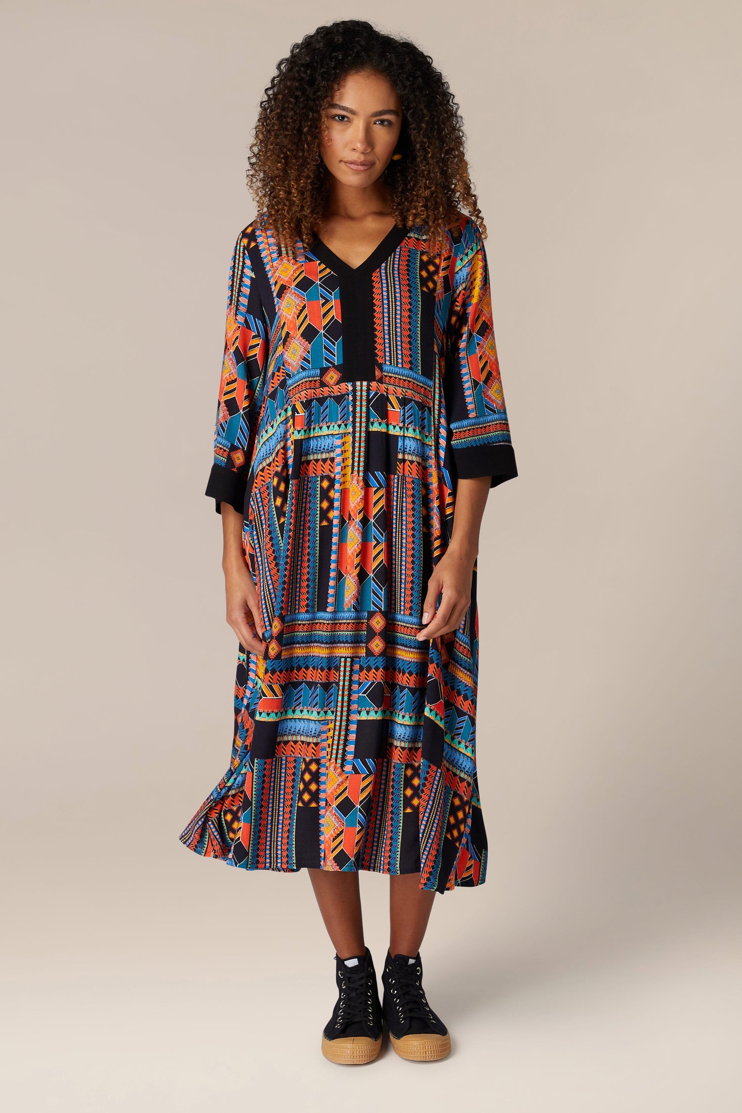 A woman wearing a Bold Graphic Printed Dress, showcasing bohemian elegance.