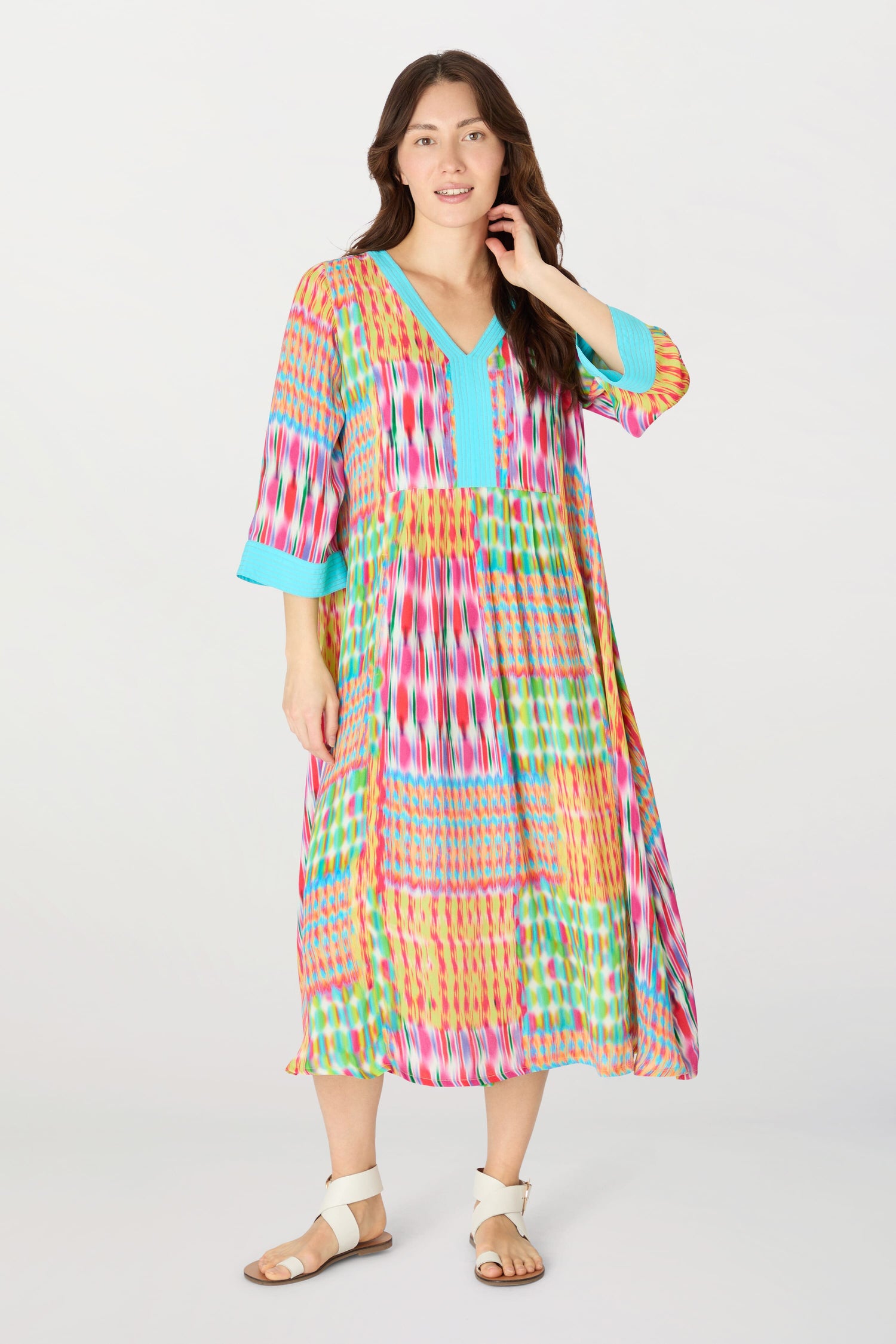 A woman wearing a vibrant floaty Kaleidoscope Ikat Flare Dress made of planet-conscious viscose.