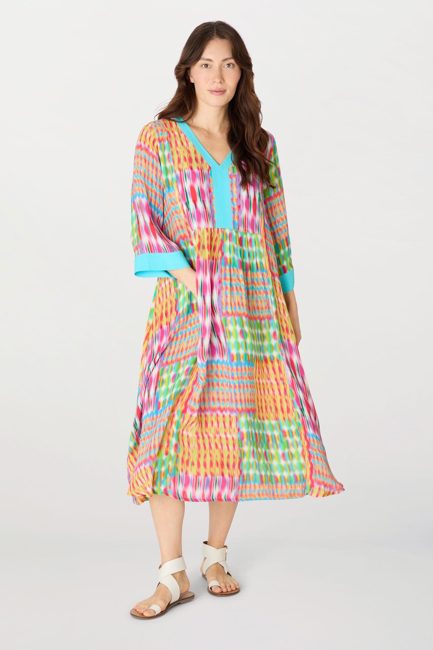 A woman wearing a Kaleidoscope Ikat Flare Dress made from planet-conscious viscose.