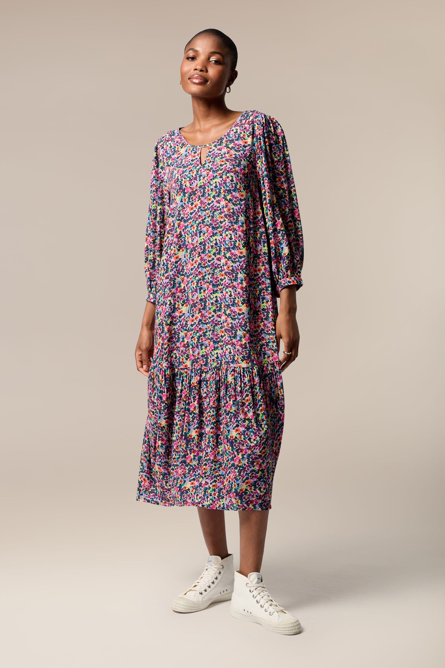A chic model wearing the Miniature Floral Garden Dress.