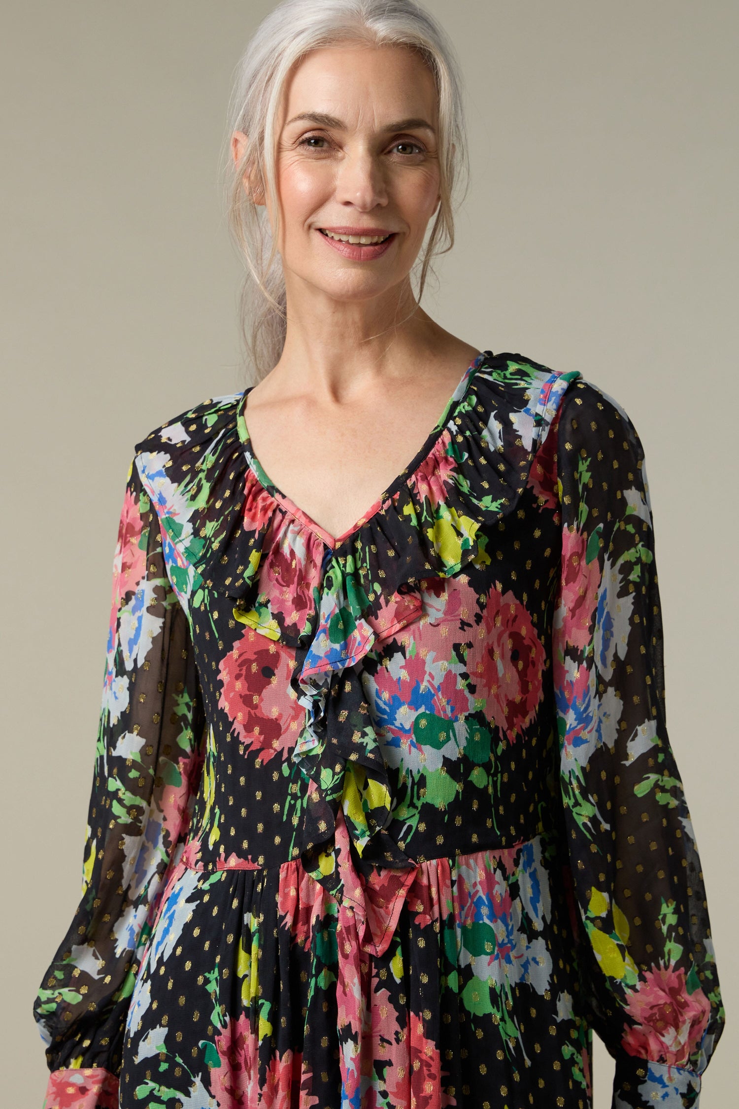 A woman wearing the Floral Bouquet Frill Dress with a free-flowing fit.