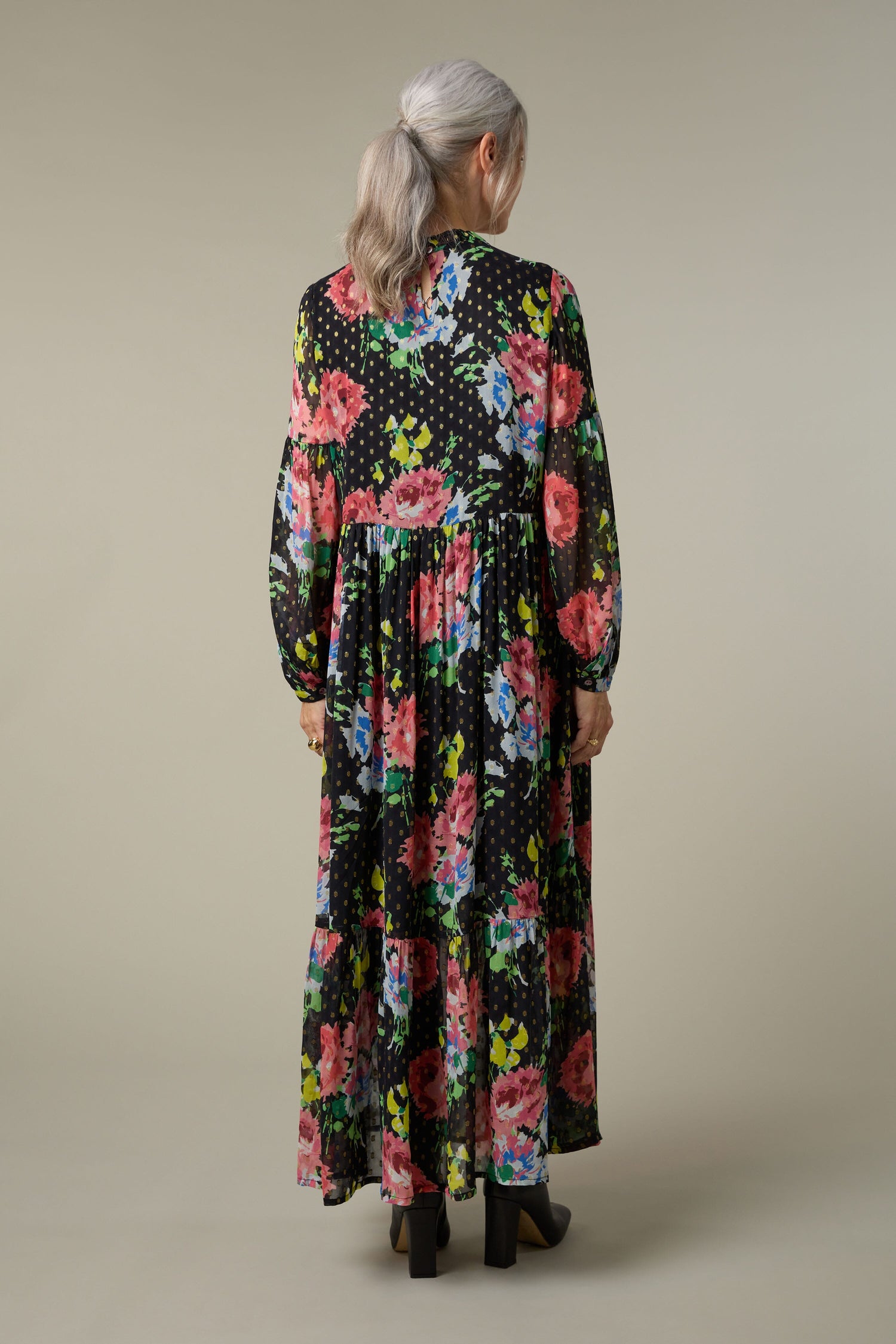 The back view of a woman wearing the Floral Bouquet Maxi Dress.