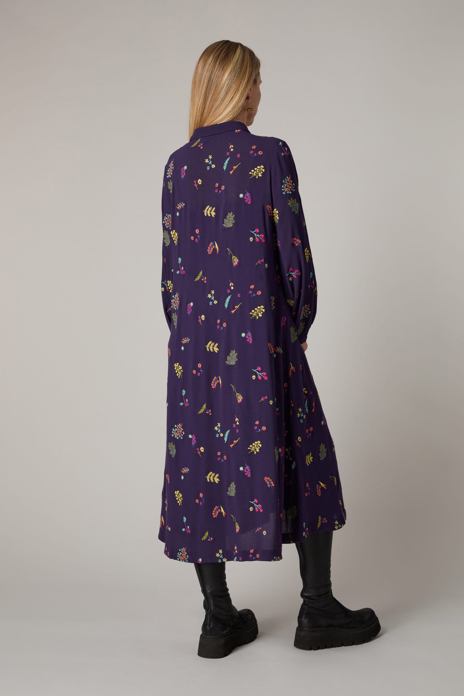 The back view of a woman wearing a Winter Sprig Crepe Shirt Dress.