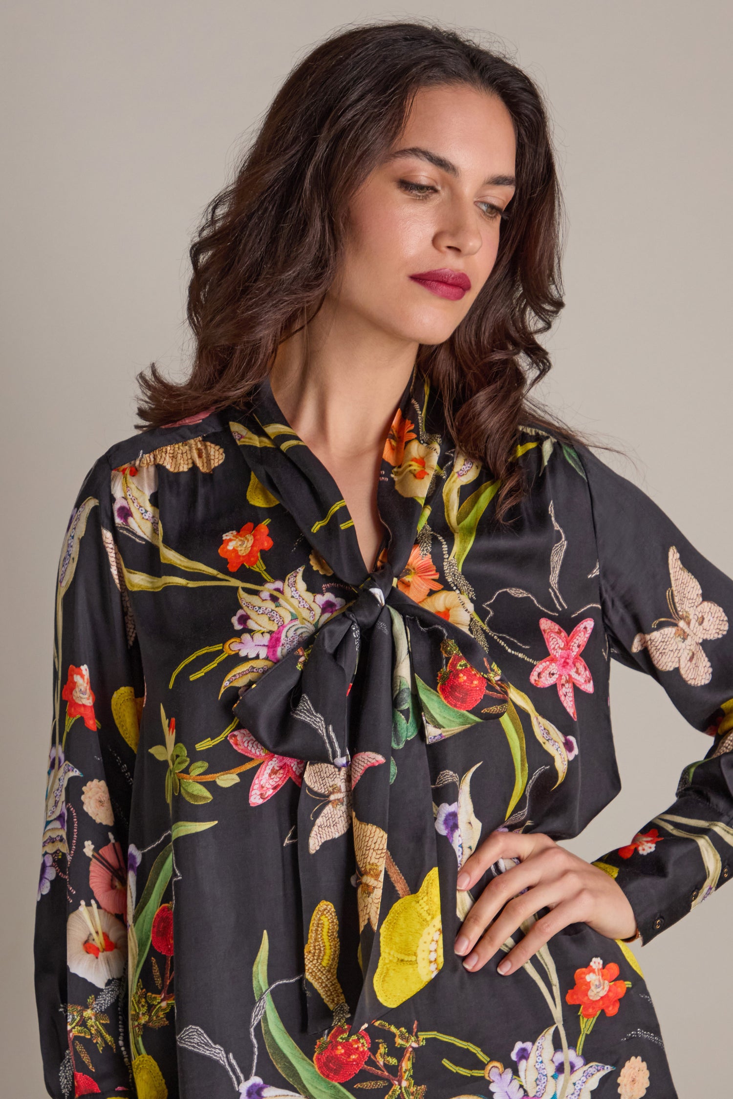 A person wearing a Vintage Floral Tie Front Dress poses with one hand on their hip against a neutral background.