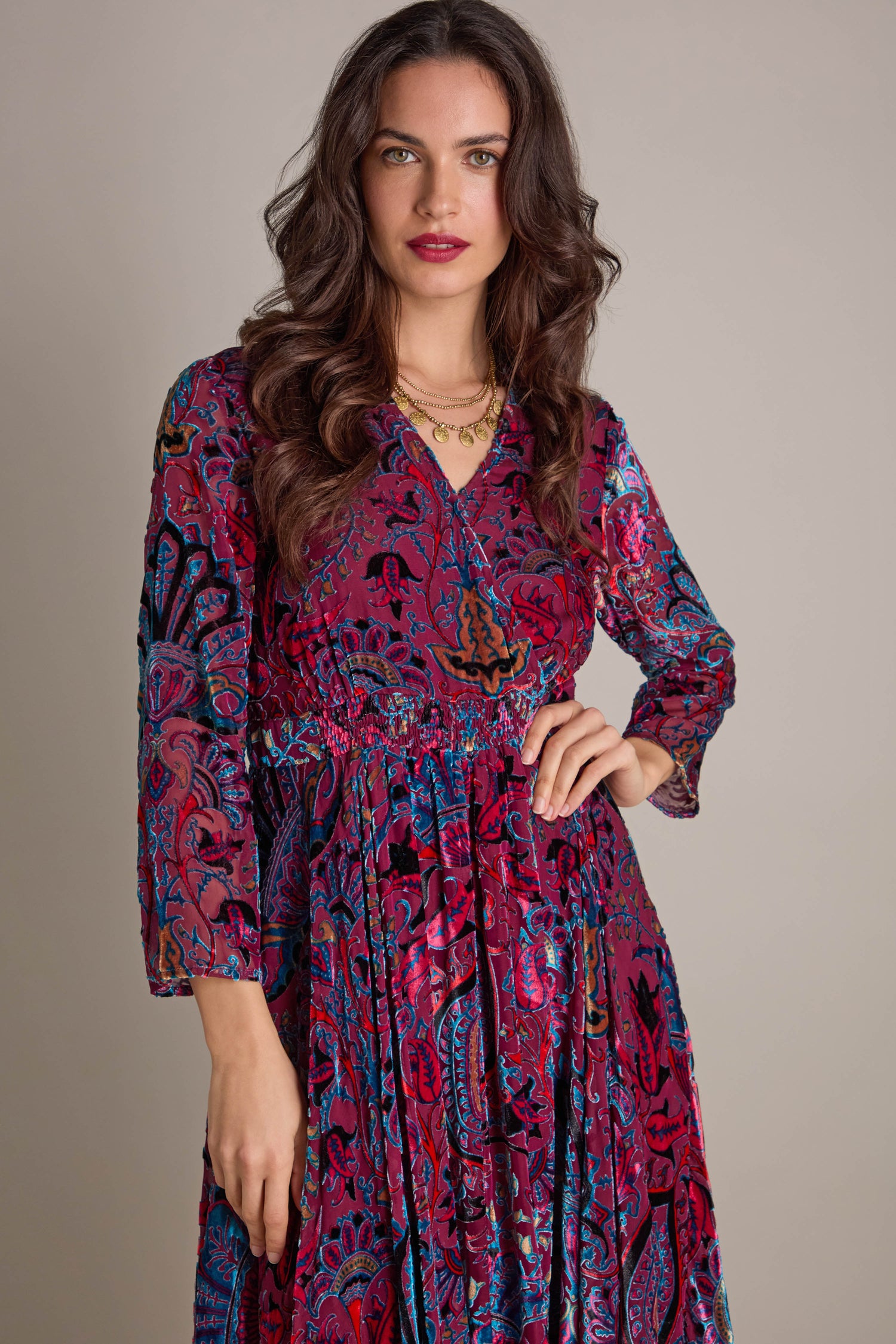 A woman in a stunning Winter Paisley Devore Flared Dress enters the scene, featuring a graceful A-line silhouette embellished with detailed paisley designs.