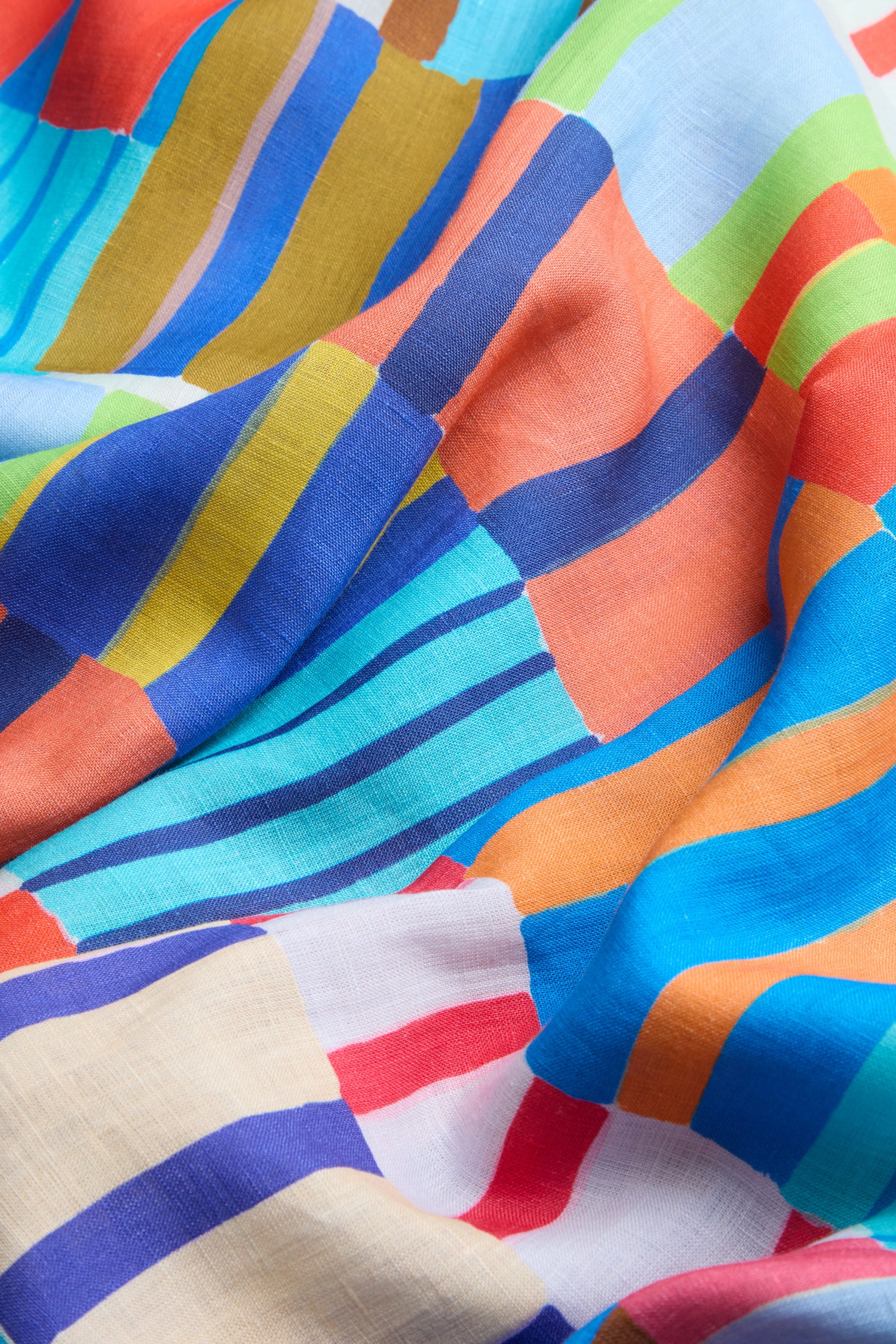 The Painted Stripes A-Line Dress features colorful, wavy hand-painted patterns in blue, orange, yellow, green, red, and white—slightly wrinkled and overlapping—perfect for a vibrant linen look.