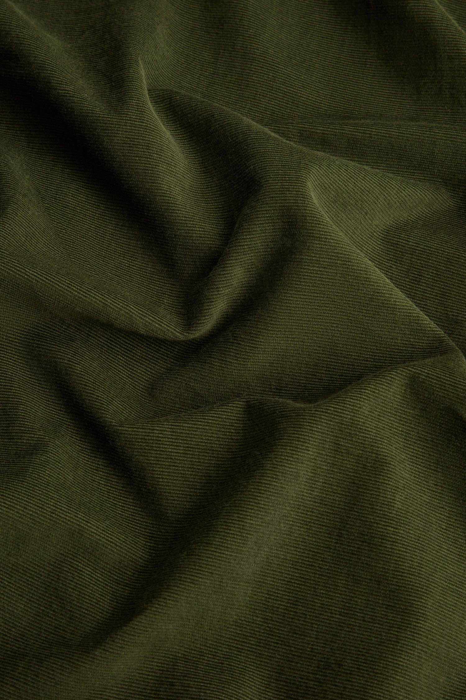 Forest Pinwale Cord Shirt Dress featuring olive green corduroy fabric with visible ridges and soft folds, creating a textured and slightly wrinkled surface—perfect for crafting a stylish and classic look.