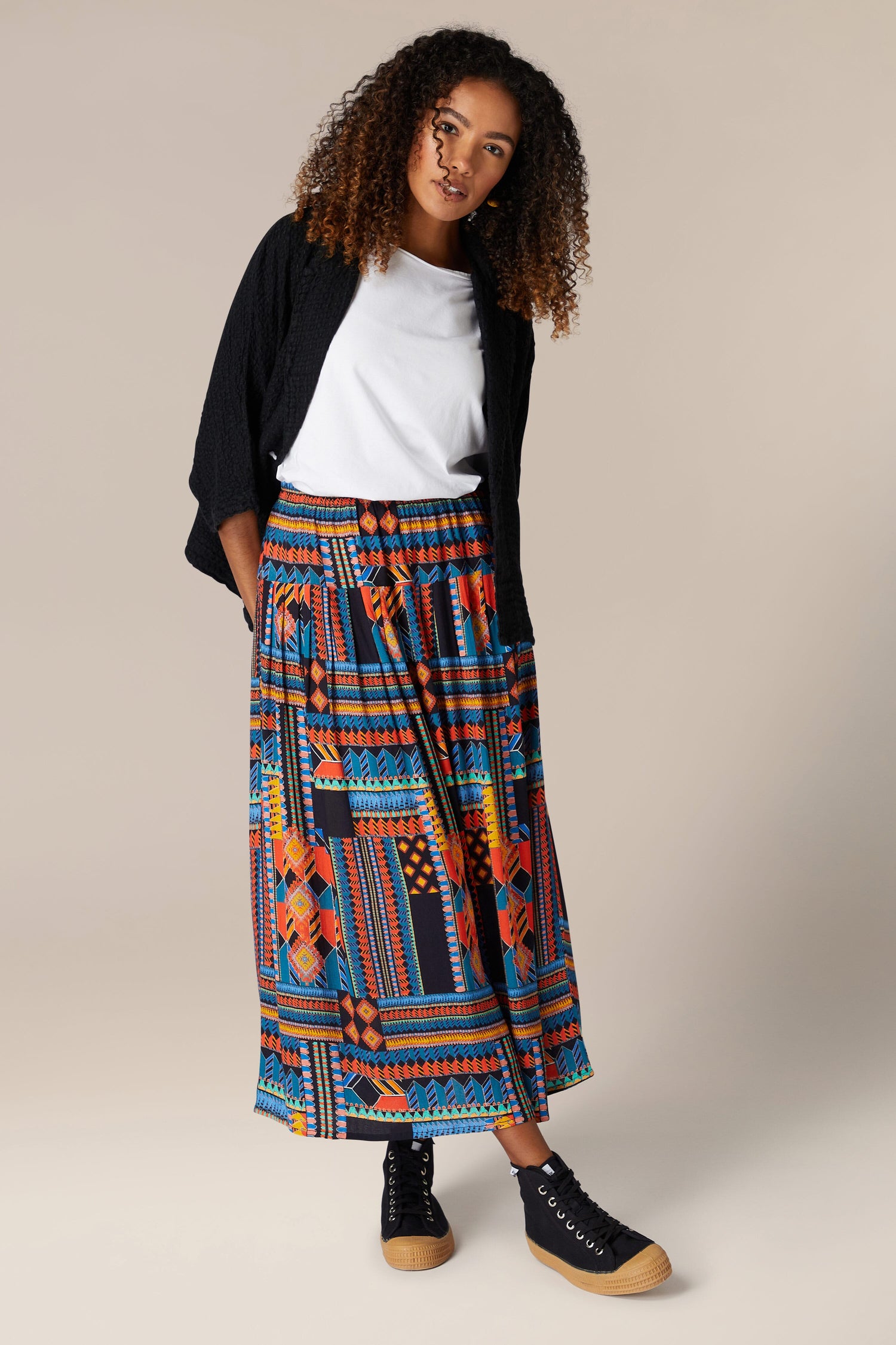 A woman wearing a Bold Graphic Printed Skirt.