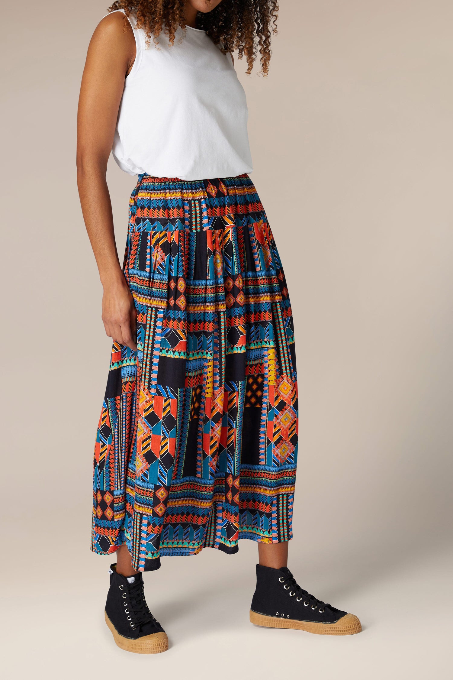 A woman wearing a Bold Graphic Printed Skirt.