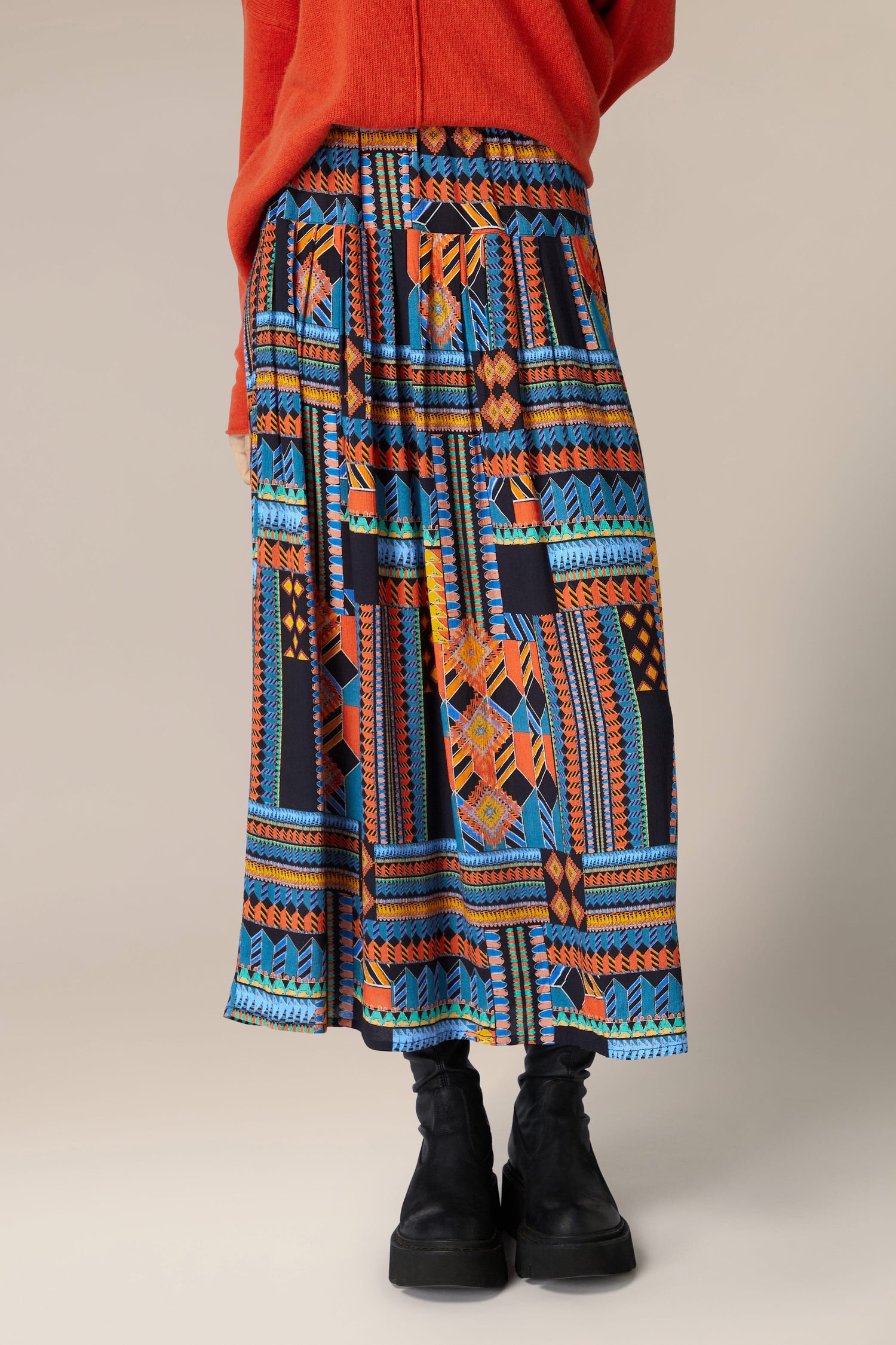 A woman wearing a Bold Graphic Printed Skirt.