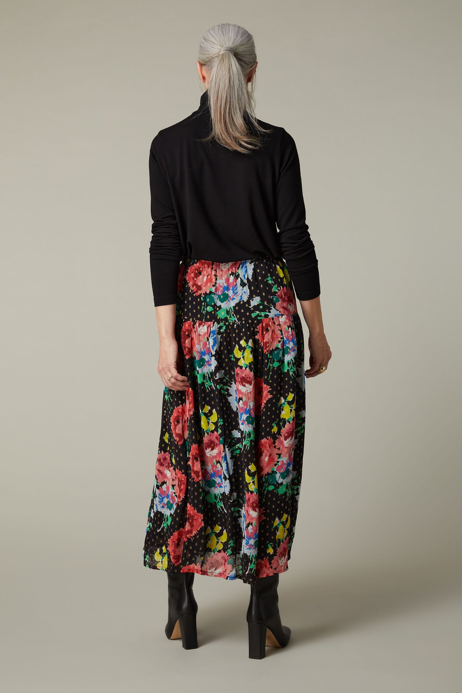 A Vintage Floral Bouquet Skirt worn by a woman.