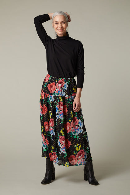 A woman wearing a Vintage Floral Bouquet Skirt.