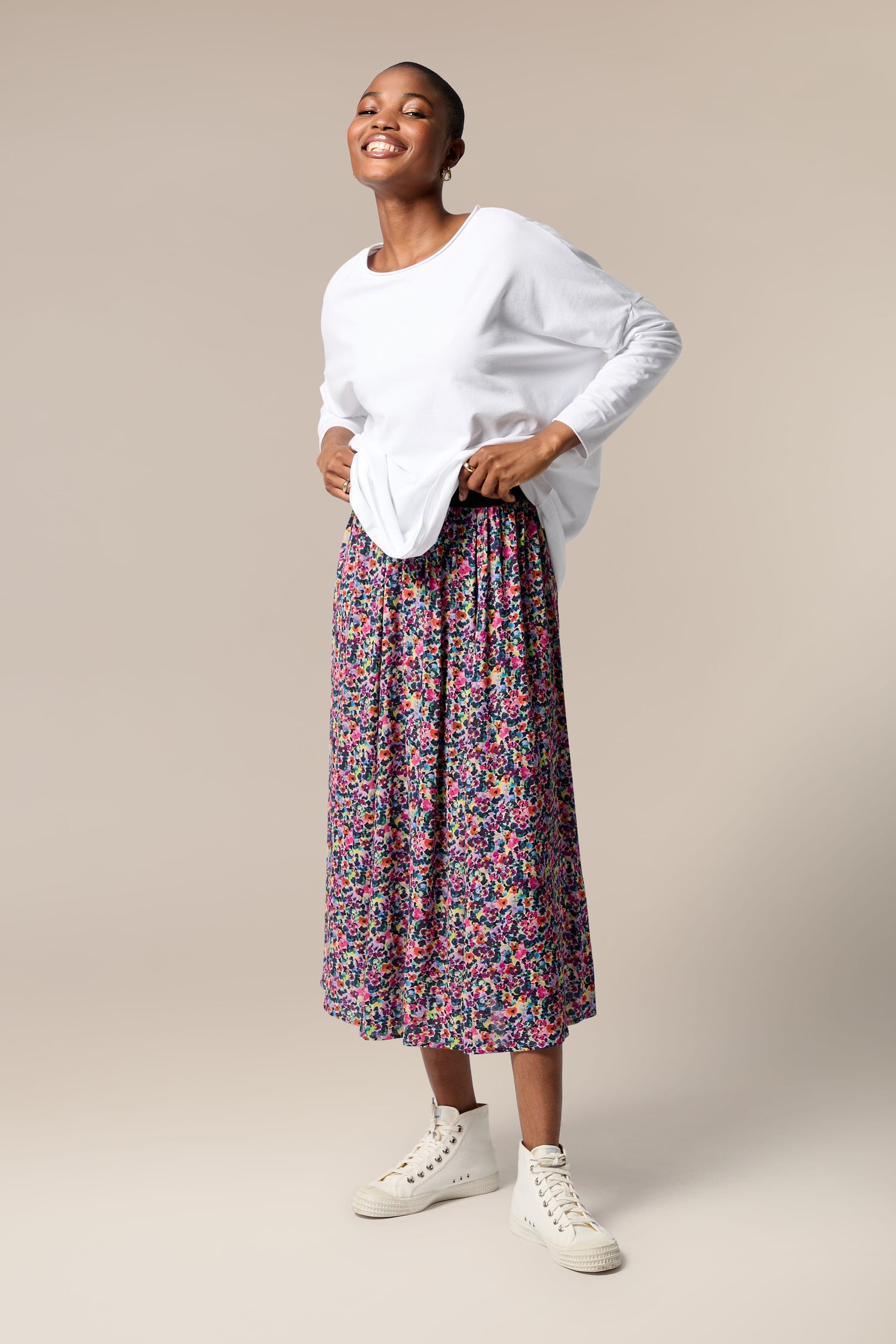 The woman is wearing a Miniature Floral Garden Skirt.