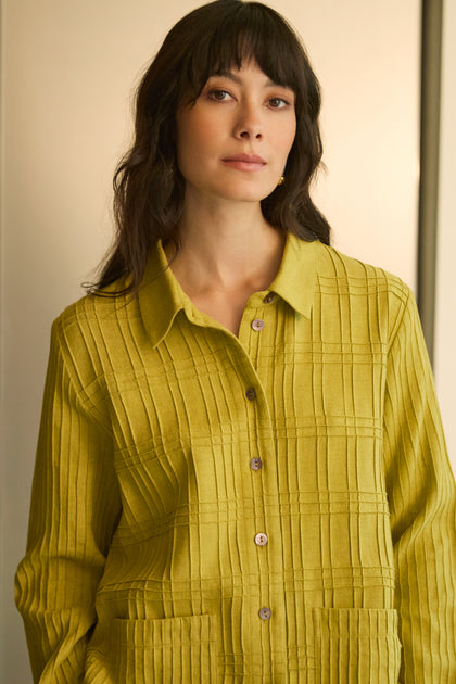 A woman with long dark hair and bangs wears the Brushed Cotton Pintuck Detail Shirt in yellow-green and looks at the camera against a neutral background.