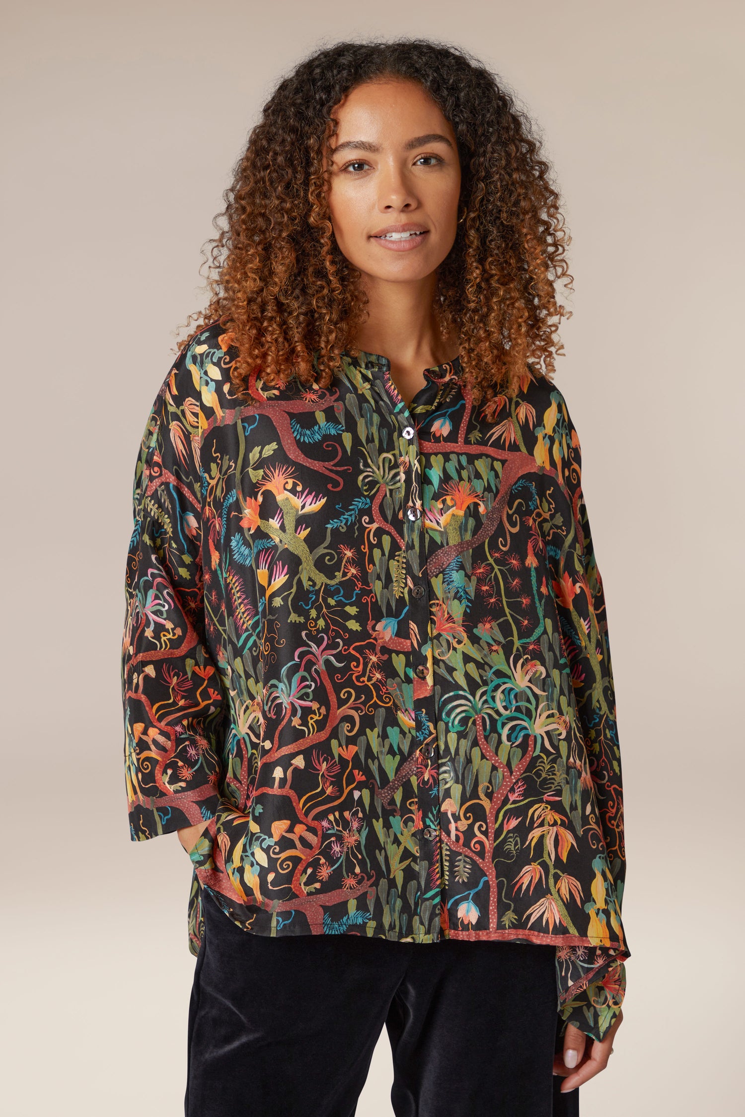A woman wearing a Faraway Jungle Silk Boxy Shirt.