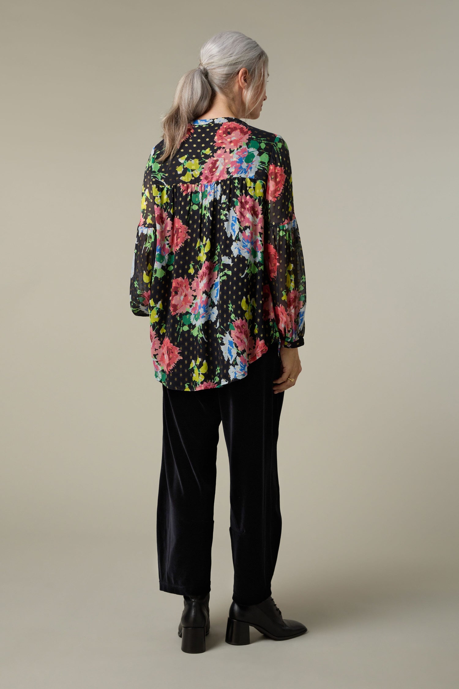 The back view of a woman wearing a Vintage Floral Bouquet Shirt.