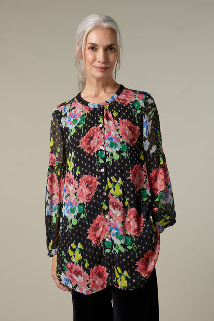 A woman wearing a vintage floral bouquet shirt.