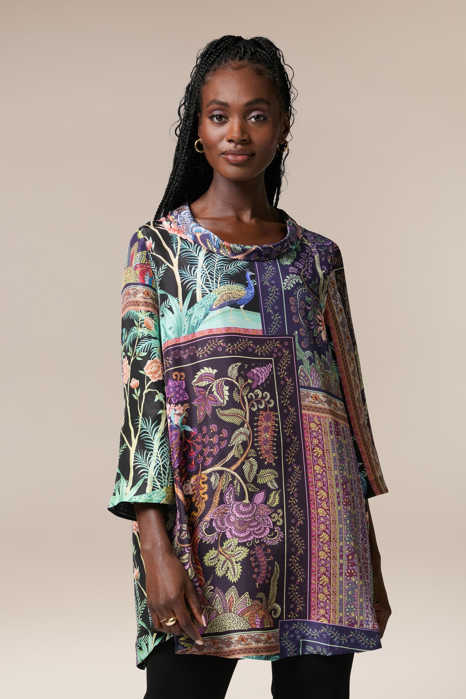 A woman adorned in the Mythical Print Silk Tunic, exuding a bohemian aesthetic through its intricate prints.