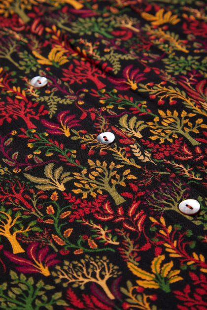 A close up of a Magical Forest Print Shirt with a forest motif of colorful trees in autumnal tones.