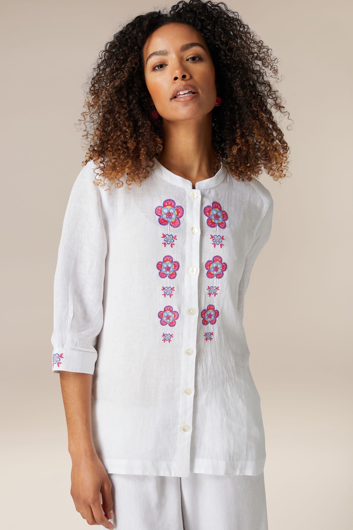 Woman wearing a pure linen Floral Embroidery Shirt, standing against a neutral background.