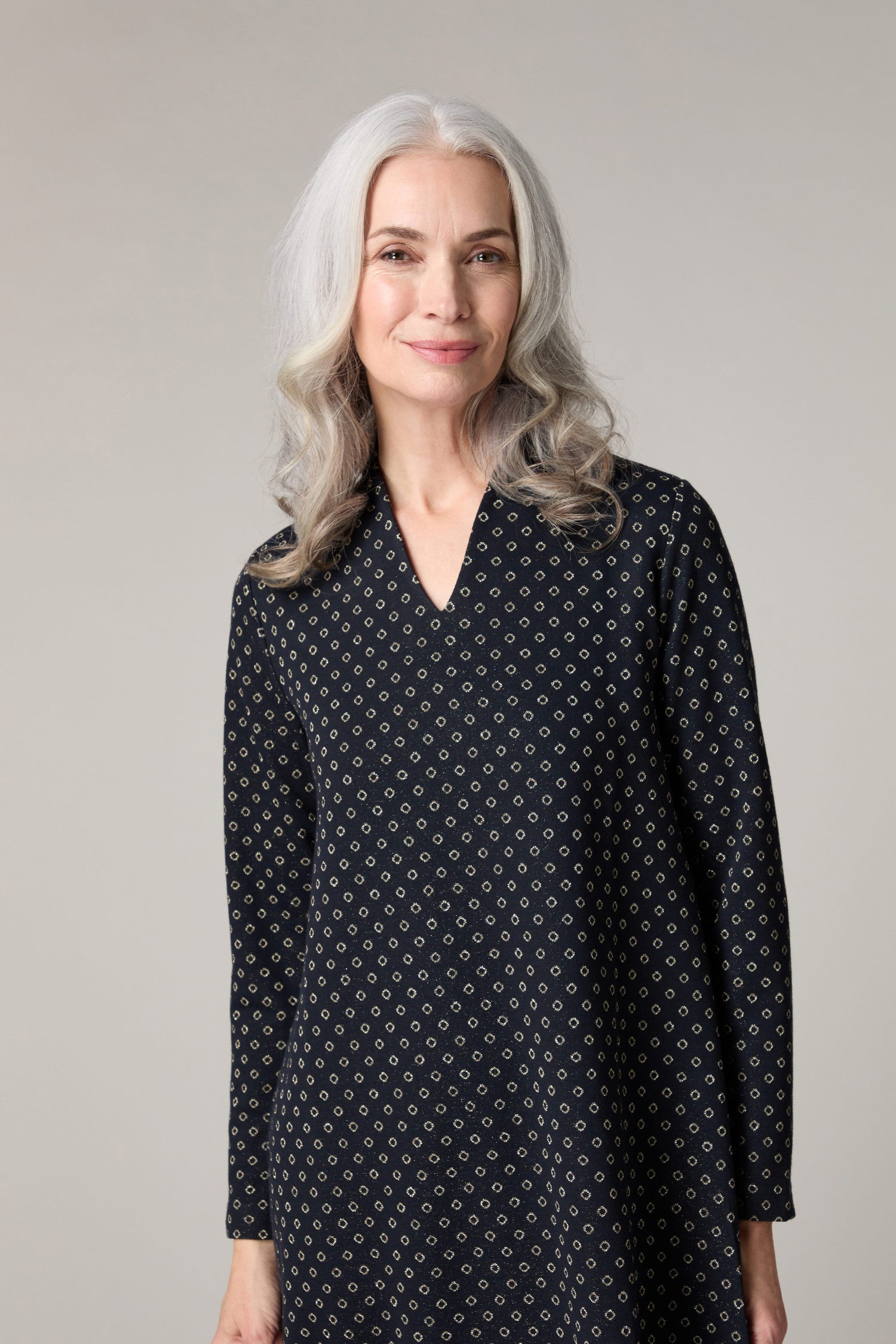 A woman wearing a Lurex Spot Jersey Dress.