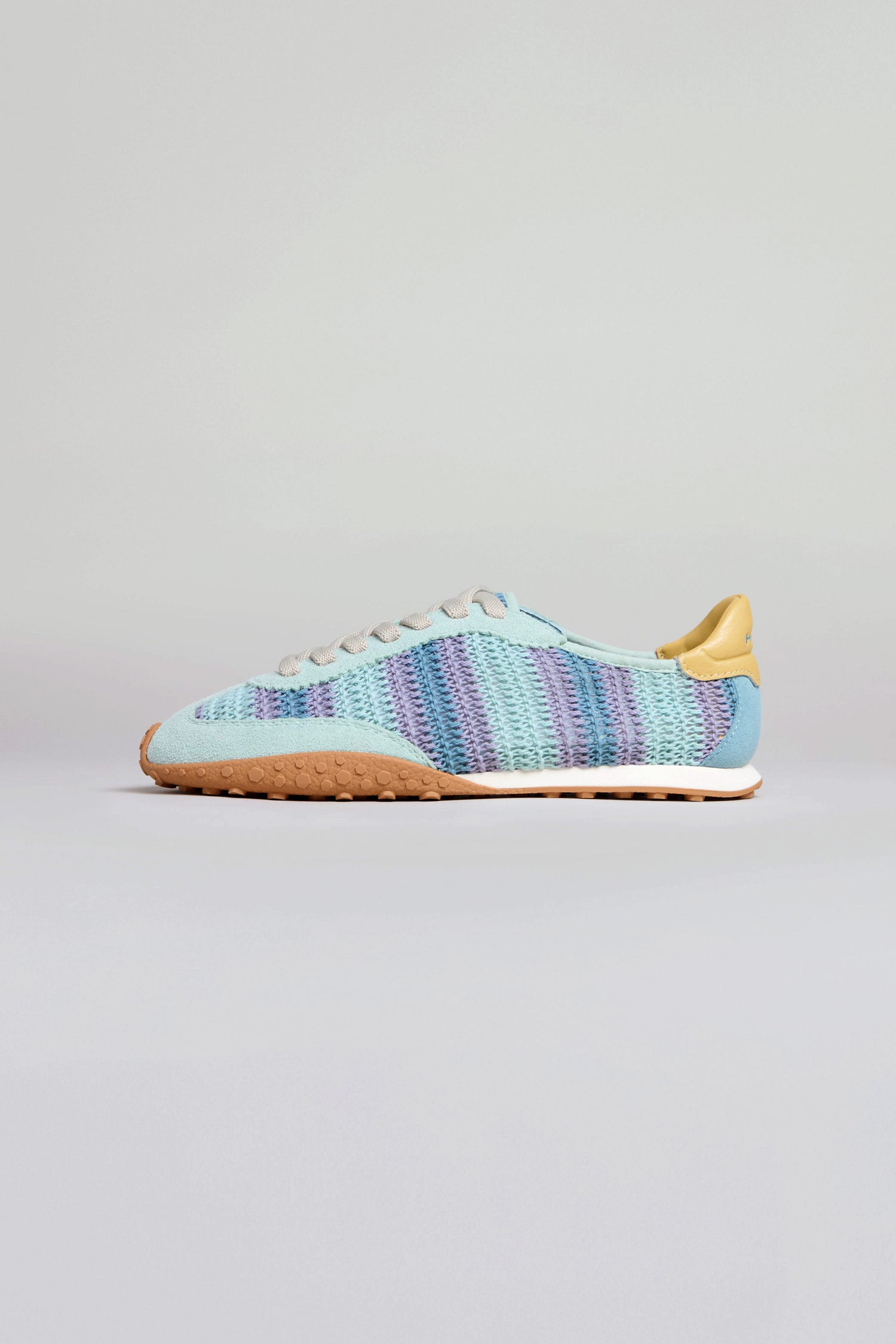 Bridge Woven Light Blue Crochet Trainers with a striped knit and crochet upper, beige heel tab, white laces, and a textured gum sole are shown against a plain light background.