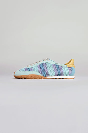 Bridge Woven Light Blue Crochet Trainers with a striped knit and crochet upper, beige heel tab, white laces, and a textured gum sole are shown against a plain light background.