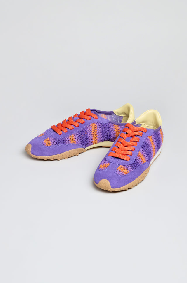 Bridge Woven Purple Crochet Trainers feature orange laces, a cushioned sole, beige outsoles, and light yellow inner lining. Shown against a plain light background.