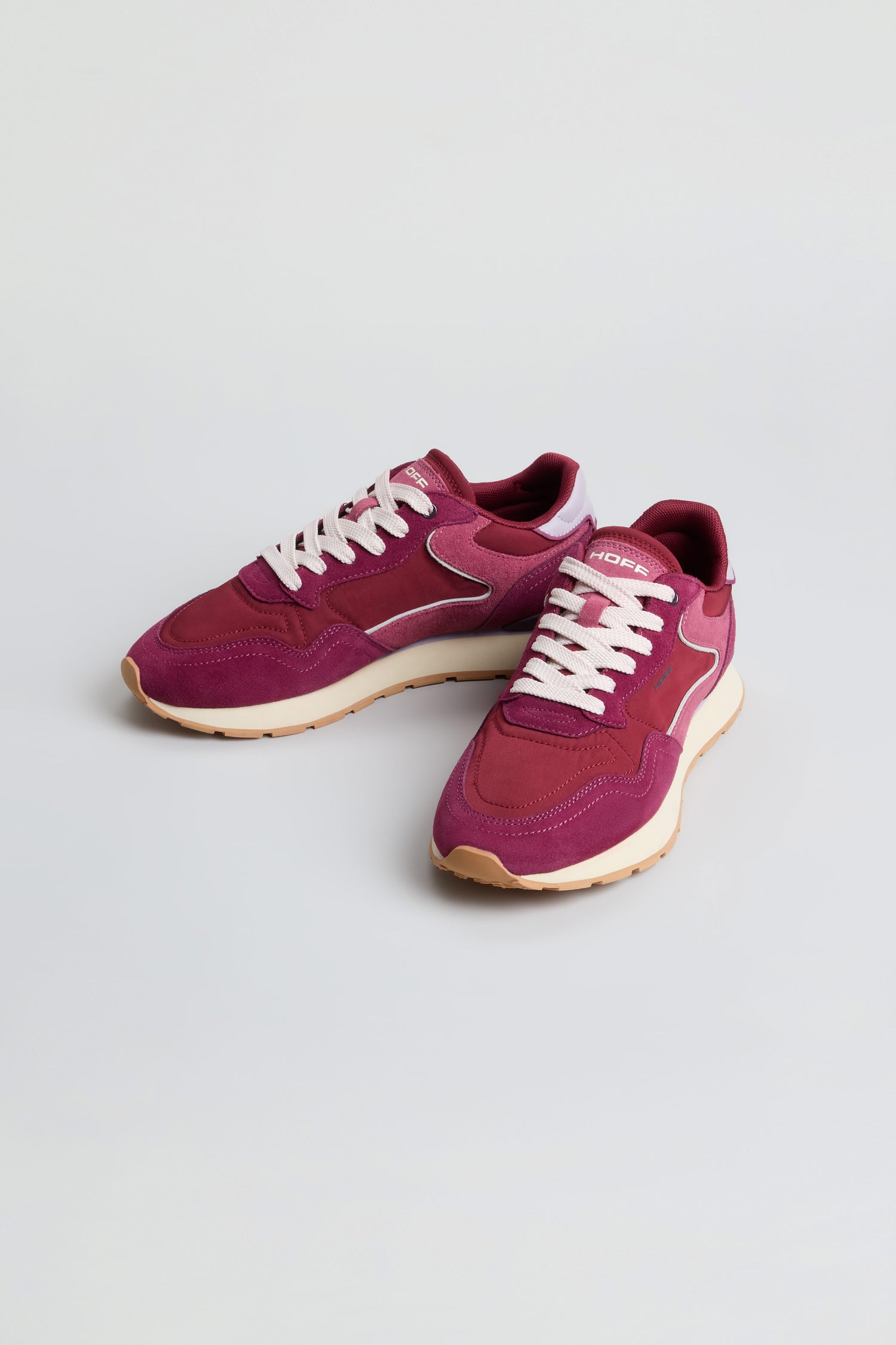 A pair of City Trainers in purple with white accents and laces, featuring beige outsoles, displayed on a plain light surface.